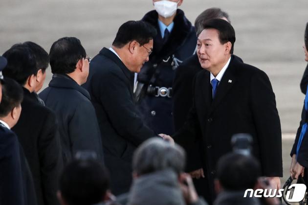 윤석열 토토사이트추천이 아랍에미리트 국빈방문, 스위스 다보스포럼 등 순방일정을 마치고 21일 오전 경기 성남 서울공항에 도착해 정진석 국민의힘 비상대책위원장과 악수하고 있다. 2023.1.21/뉴스1 ⓒ News1 이승배 기자