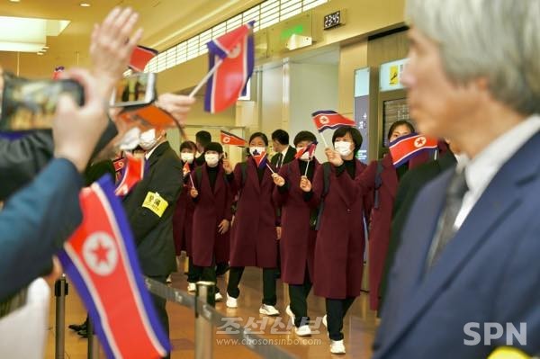 25일 일본 하네다 공항에 도착한 북한 여자축구 대표팀을 조총련 관계자들이 환영하고 있다.(사진=조선신보)