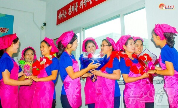 카지노 룰렛 사이트 애국편직물공장에서 노동자들이 서로 꽃다발을 주며 격려하고 있다.(사진=노동신문/뉴스1)
